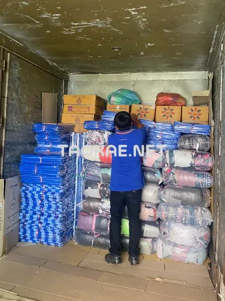 พนักงานกำลังจัดเรียงสินค้าขึ้นรถขนส่งขนาดใหญ่